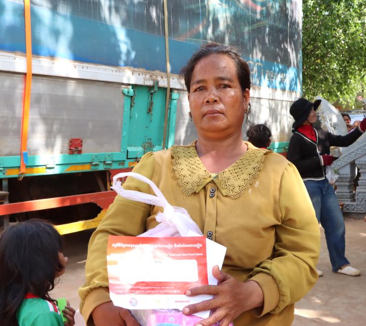 A woman holding emergency relief package