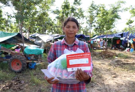 A woman holding emergency relief package