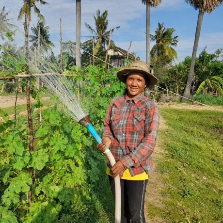 Farmer holding water pipe