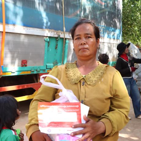 A woman holding emergency relief package
