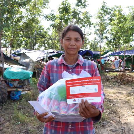 A woman holding emergency relief package
