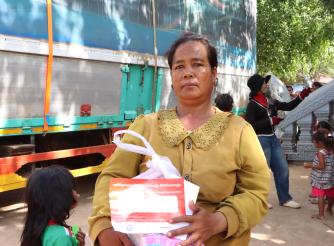A woman holding emergency relief package